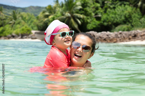 Mother And Daughter Swimming In The Sea
