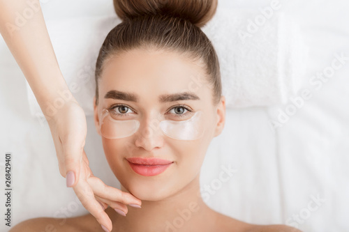 Photo Under Eye Treatment. Woman With Patches Relaxing In Spa Salon