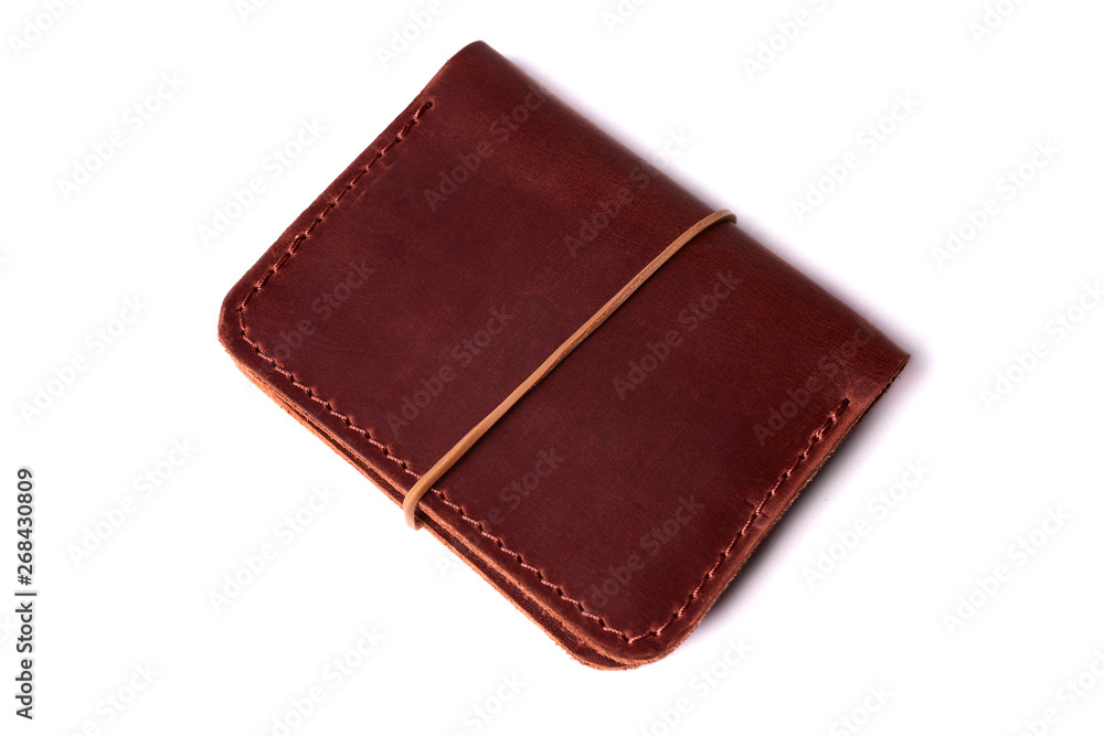 Handmade red color leather cardholder with rubber band isolated on white background closeup. Stock photo of handmade luxury accessories. Handmade red color leather cardholder with rubber band isolated on white background closeup. Stock photo of handmade luxury accessories.