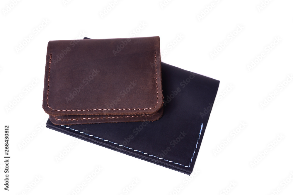 Handmade brown cardholder and black passport cover isolated on white background closeup. Stock photo of handmade luxury accessories. Handmade brown cardholder and black passport cover isolated on white background closeup. Stock photo of handmade luxury accessories.