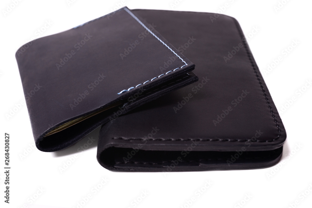 Handmade blue passport cover and black purse isolated on white background closeup. Stock photo of isolated handmade luxury accessories. Handmade blue passport cover and black purse isolated on white background closeup. Stock photo of isolated handmade luxury accessories.