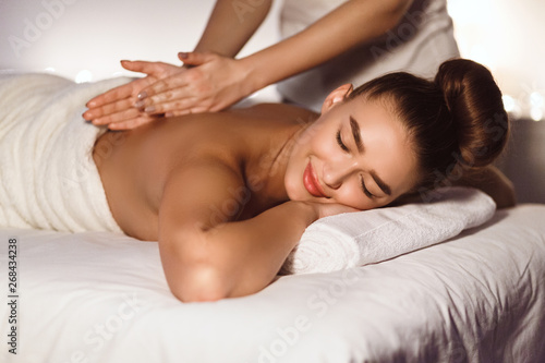 Body Care. Woman Enjoying Back Massage In Spa