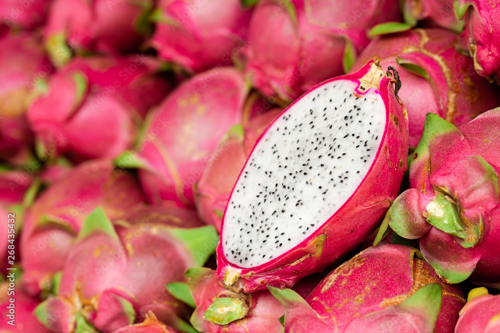 Fresh red dragon fruit in the market for sale. Tropical fruit, close up Fresh red dragon fruit in the market for sale. Tropical fruit, close up