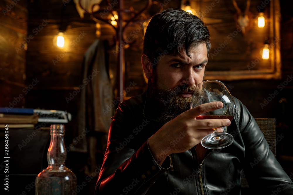Man with beard holds glass brandy. Macho drinking. Degustation, tasting. Handsome stylish bearded man. Confident man. Man with beard holds glass brandy. Macho drinking. Degustation, tasting. Handsome stylish bearded man. Confident man.