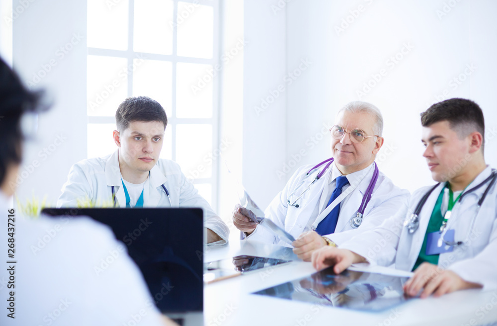 Medical team sitting and discussing at table Medical team sitting and discussing at table