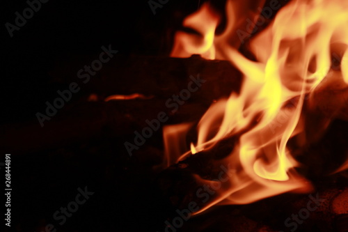 Glowing Yellow and orange colour fire is flamming and burning on a black background.Abstract design © #CHANNELM2