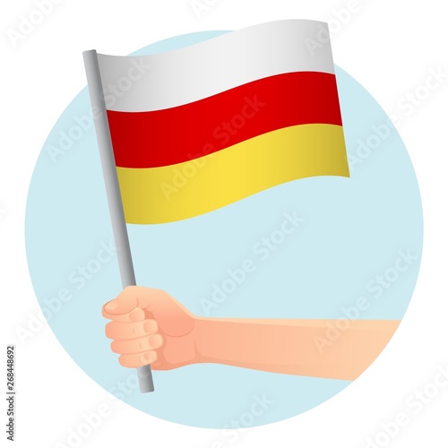 south ossetia flag in hand