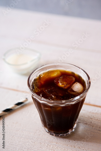 glass of iced coffee on white wooden table
