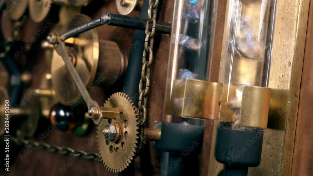 Steampunk, the mechanism of a time machine with rotating gears, flasks in which bubbles in a liquid, a chain,Very similar to a clock mechanism or a working device in the old style. Steampunk, the mechanism of a time machine with rotating gears, flasks in which bubbles in a liquid, a chain,Very similar to a clock mechanism or a working device in the old style.