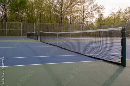 Blue tennis courts with sun flare light leak  © Don Mroczkowski