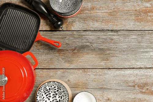 Konstfotografi Cookware set: Red enameled cast iron pot, saucepan and bowls on wooden table, t