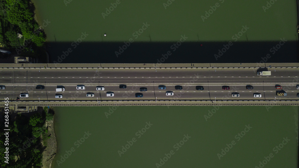 Drone's Eye View - Aerial top down view of urban traffic jam on bridge Drone's Eye View - Aerial top down view of urban traffic jam on bridge