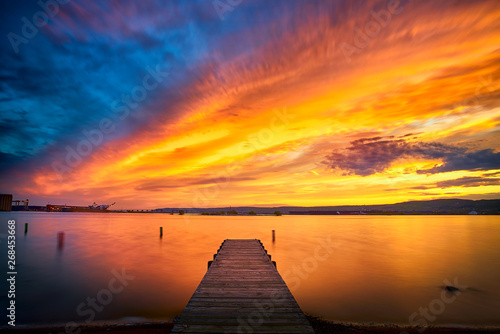 Fototapeta Naklejka Na Ścianę i Meble -  Beautiful Sunset Clouds over horizon and fishing pier