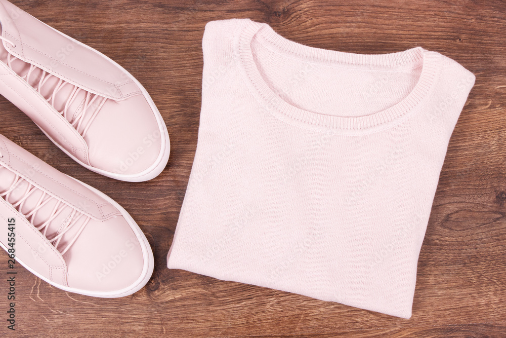 Womanly leather shoes and woolen sweater on rustic boards Womanly leather shoes and woolen sweater on rustic boards