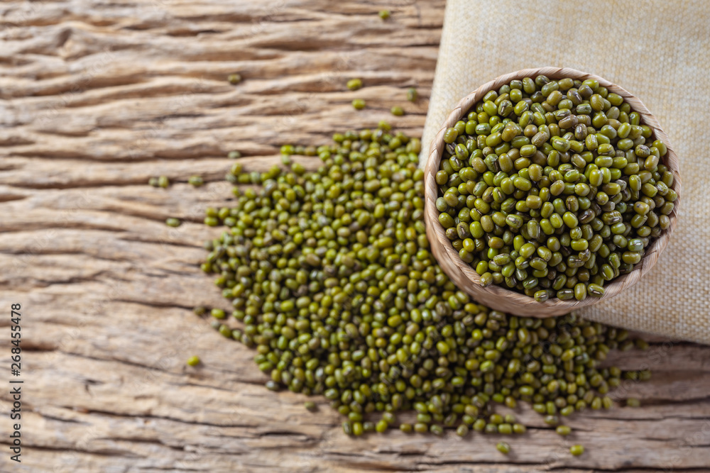 Mung bean seeds on a wooden background in the kitchen Mung bean seeds on a wooden background in the kitchen