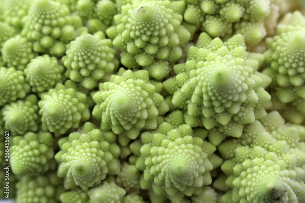 Abstract organic green spiral texture formed from close up detail of Romanesco broccoli, also known as Roman cauliflower. Abstract organic green spiral texture formed from close up detail of Romanesco broccoli, also known as Roman cauliflower.
