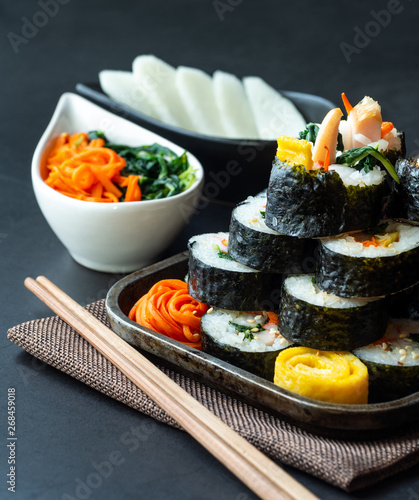 Set of kimbub or sushi roll in steel plate ready to serve in korean style menu with chopstick.