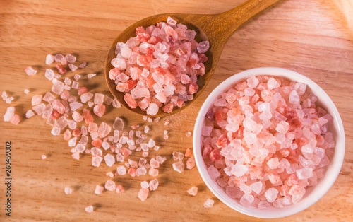 Pink salt from Bolivian in spoon on wooden plate