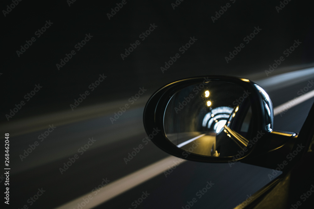 Oval mirror car reflecting highway driving inside a tunnel Oval mirror car reflecting highway driving inside a tunnel