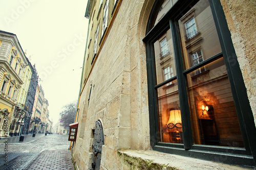 Cozy light at home. Europian architecture - facade and window of old stone building.