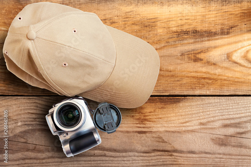 Baseball cap camera on a wooden background close-up.