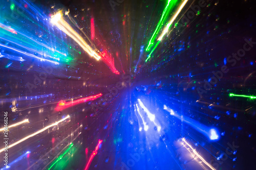 Сolorful traces of lanterns, headlights, receding into the distance in fast motion, unreal, hyper-space. Abstract photography. Night illuminated. Colorful traces and light patterns.