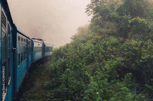 Train in misty foggy mountain railroad, beautiful mountains landscape. Are Lanka, way to Ella