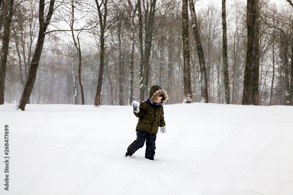 Boy winter snowball game.