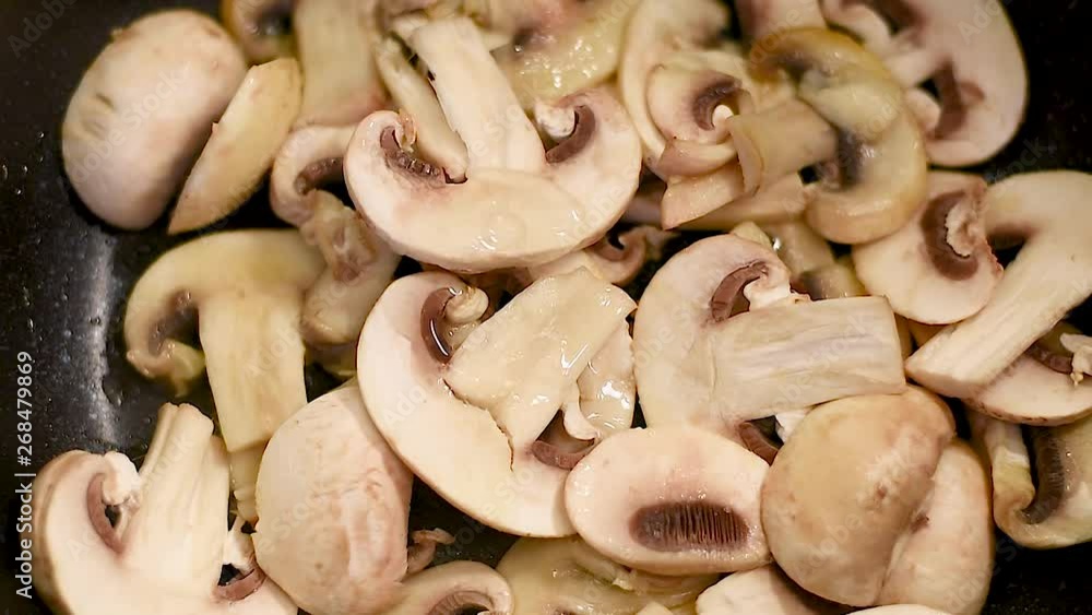 Mushrooms each in a pan with olive oil, close-upю Mushrooms are cooked in a pan over low heat with vegetable oil Mushrooms each in a pan with olive oil, close-upю Mushrooms are cooked in a pan over low heat with vegetable oil