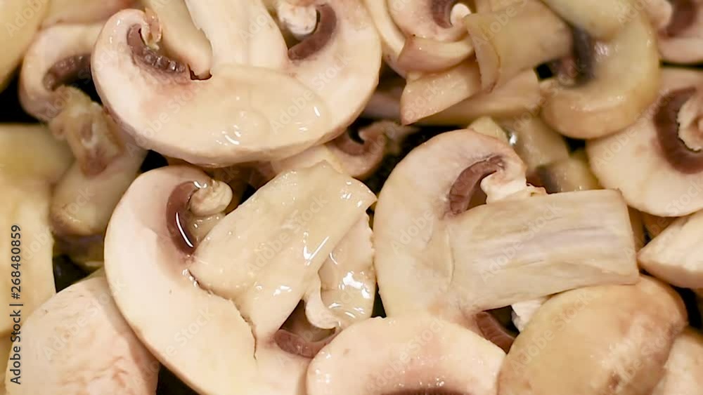 Mushrooms each in a pan with olive oil, close-upю Mushrooms are cooked in a pan over low heat with vegetable oil Mushrooms each in a pan with olive oil, close-upю Mushrooms are cooked in a pan over low heat with vegetable oil