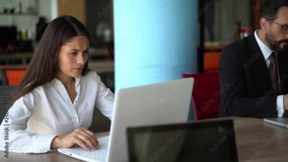 Beautiful business people are using gadgets in office Beautiful business people are using gadgets in office