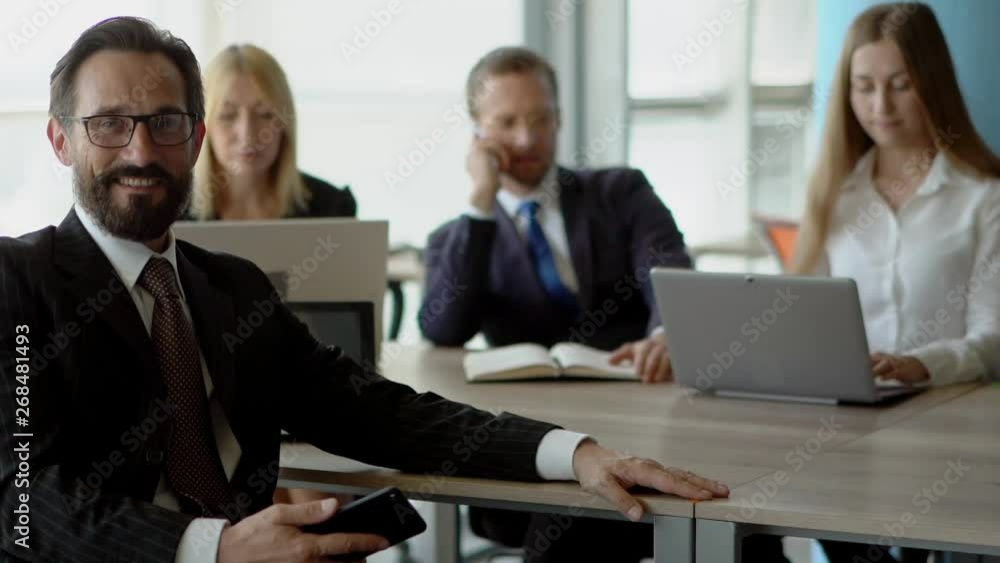 Beautiful business people are using gadgets in office Beautiful business people are using gadgets in office