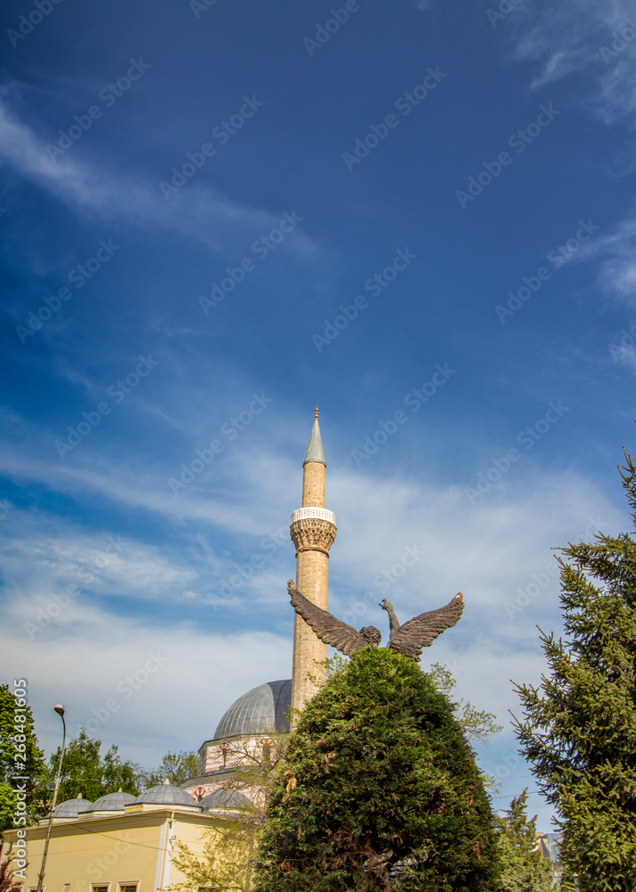 City landscape of Bitola with a minaret against the background of a beautiful cloudy sky.