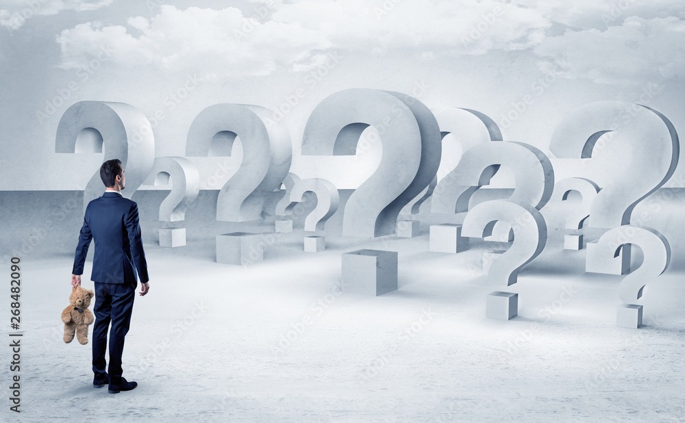 Businessman standing and looking to a bunch of question mark signs
Businessman standing and looking to a bunch of question mark signs