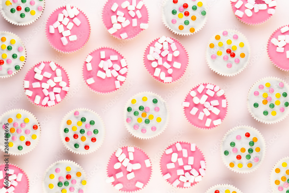 Colorful cupcakes on a white background.