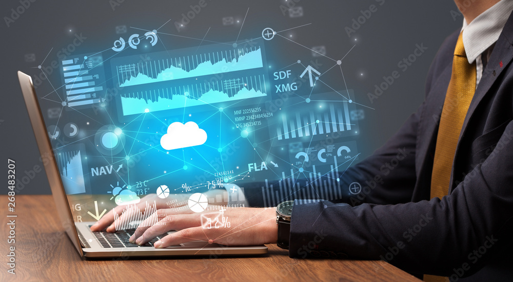 Businessman hand typing on laptop with reports and graphs concept around
Businessman hand typing on laptop with reports and graphs concept around