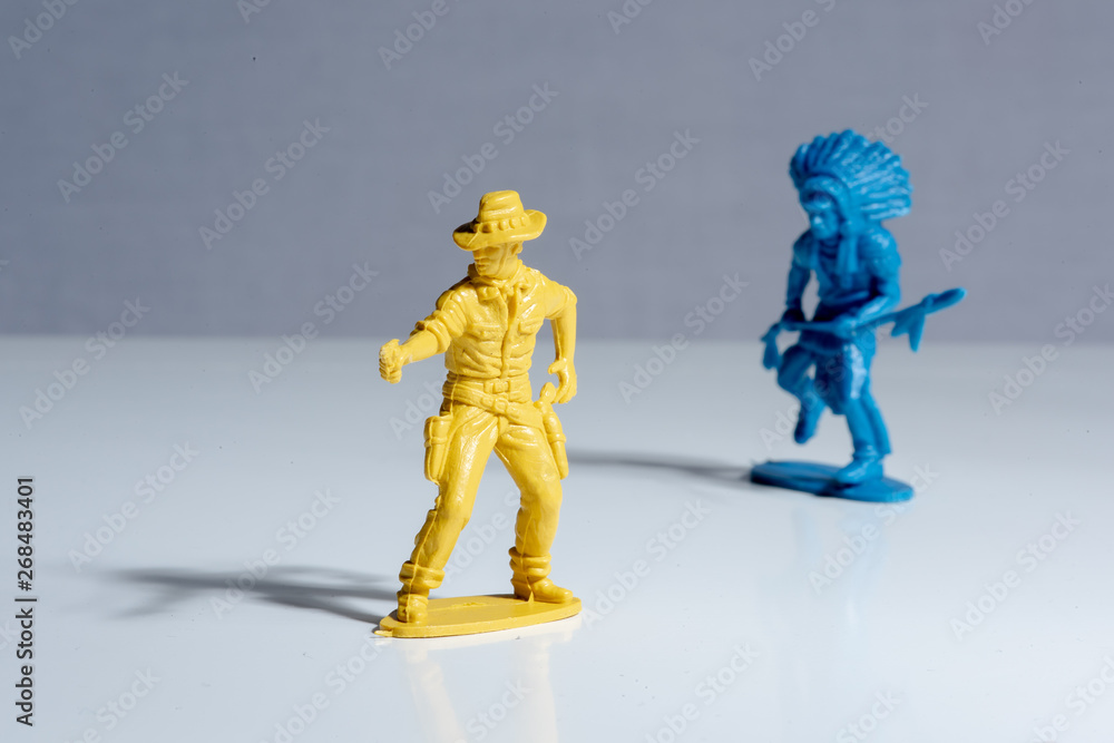Blue indian and yellow cowboy plastic toy figures. Blue indian and yellow cowboy plastic toy figures.