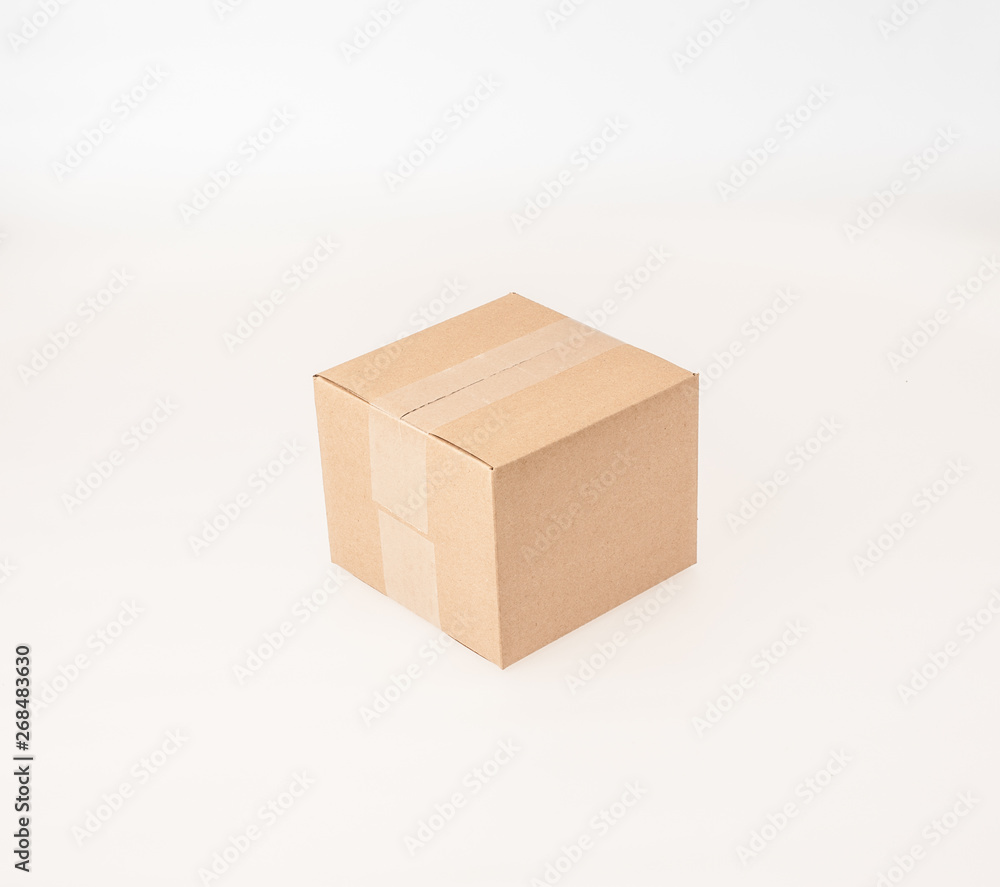 A brown, small, cardboard box on white background. A brown, small, cardboard box on white background.