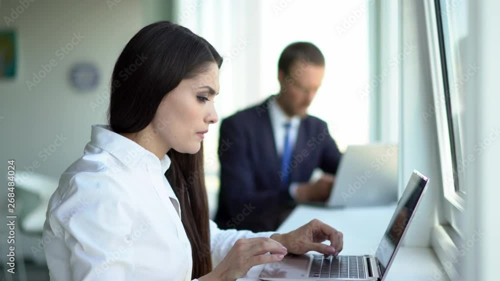 Beautiful business people are using gadgets in office Beautiful business people are using gadgets in office