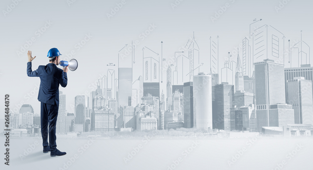 Young supervisor architect standing and replanning a big city panorama
Young supervisor architect standing and replanning a big city panorama