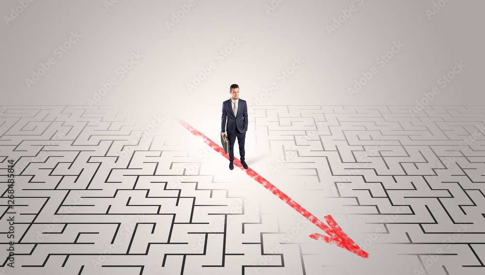 Businessman going through the maze with red arrow
Businessman going through the maze with red arrow
