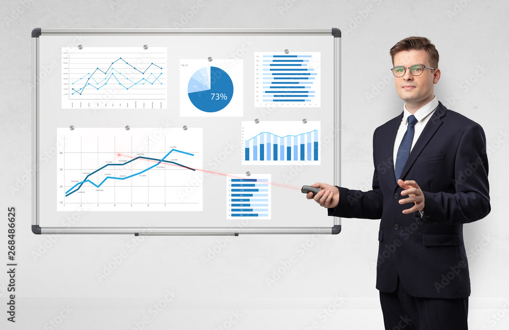 Handsome businessman presenting report on white board with laser pointer
Handsome businessman presenting report on white board with laser pointer
