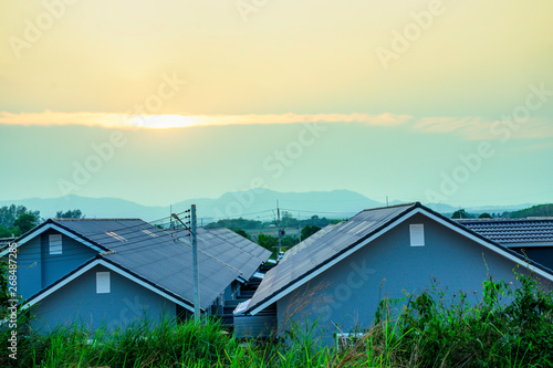 Top view roof of modern village with sunset sky  New modern town home style  Beautiful house in dawn sky  Born of new home village show of expansion of business background concept