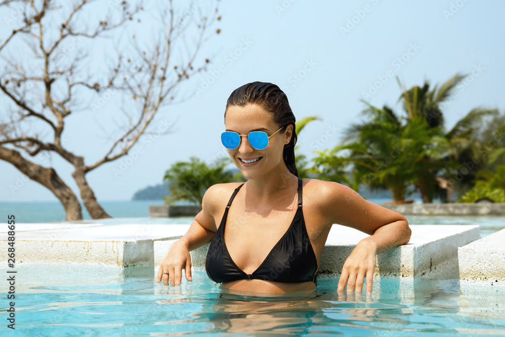 Sexy woman relaxing in the pool