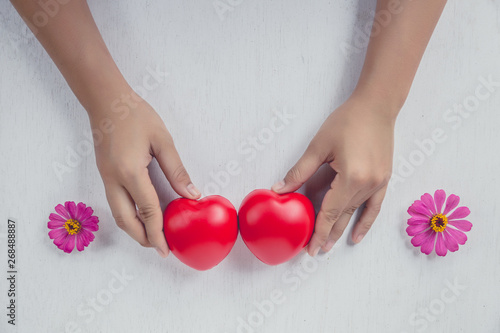 Fototapeta Naklejka Na Ścianę i Meble -  Red heart on girl hand