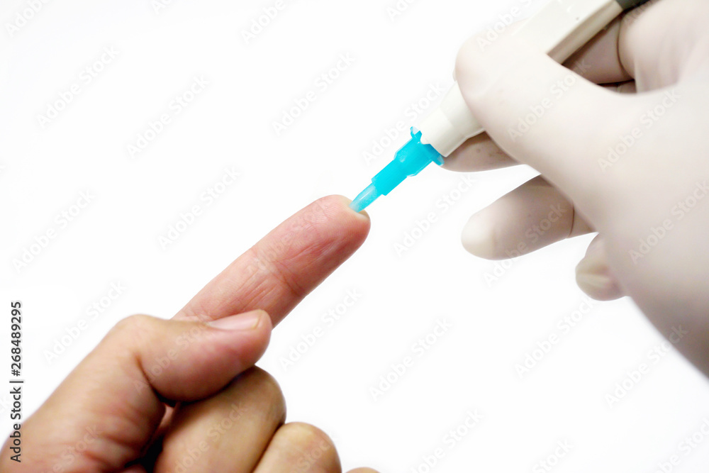 Hand of doctor in white medical glove holding needle pen stab on human forefinger to check glucose in bloods isolate on white background. Hand of doctor in white medical glove holding needle pen stab on human forefinger to check glucose in bloods isolate on white background.