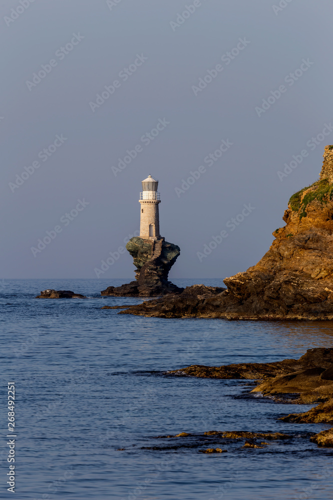 View of the town lighthouse and the sea (Greece, island Andros, Cyclades)