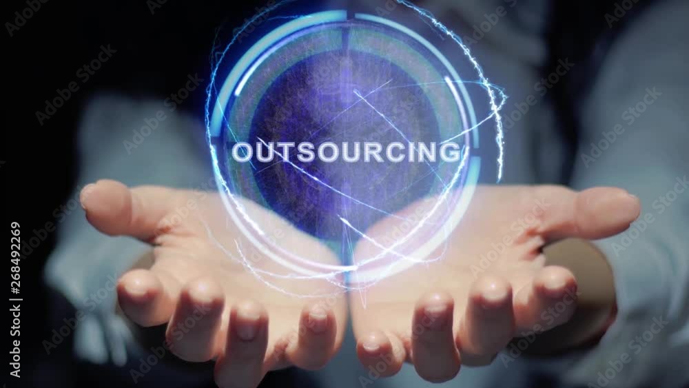 Female hands show a round conceptual hologram with text Outsourcing. Unrecognizable woman in ashen white on a black background with future holographic technology