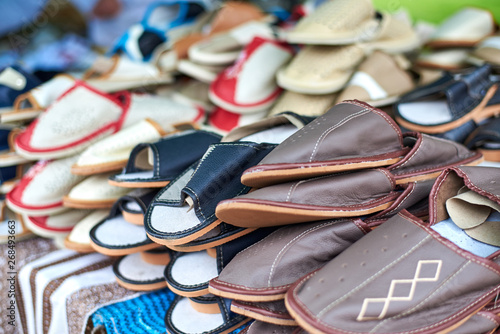 Handmade leather slippers on the market counter