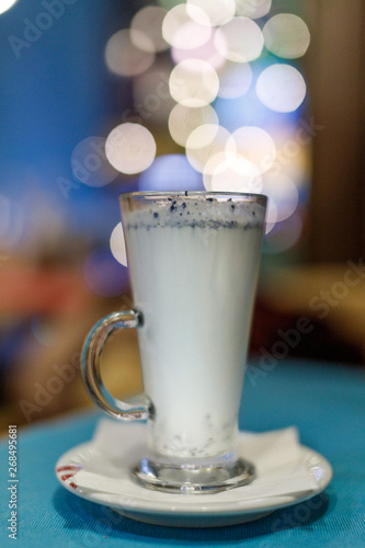 Hot milk drink with blue flowers. Shallow depth of field